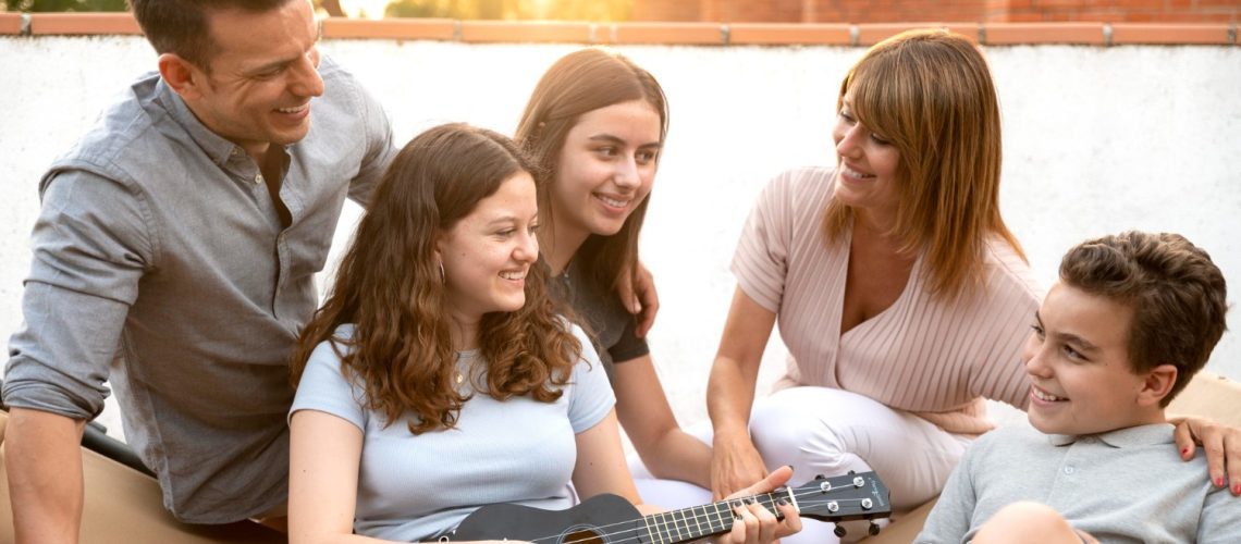 family-gathering-playing-ukulele-together